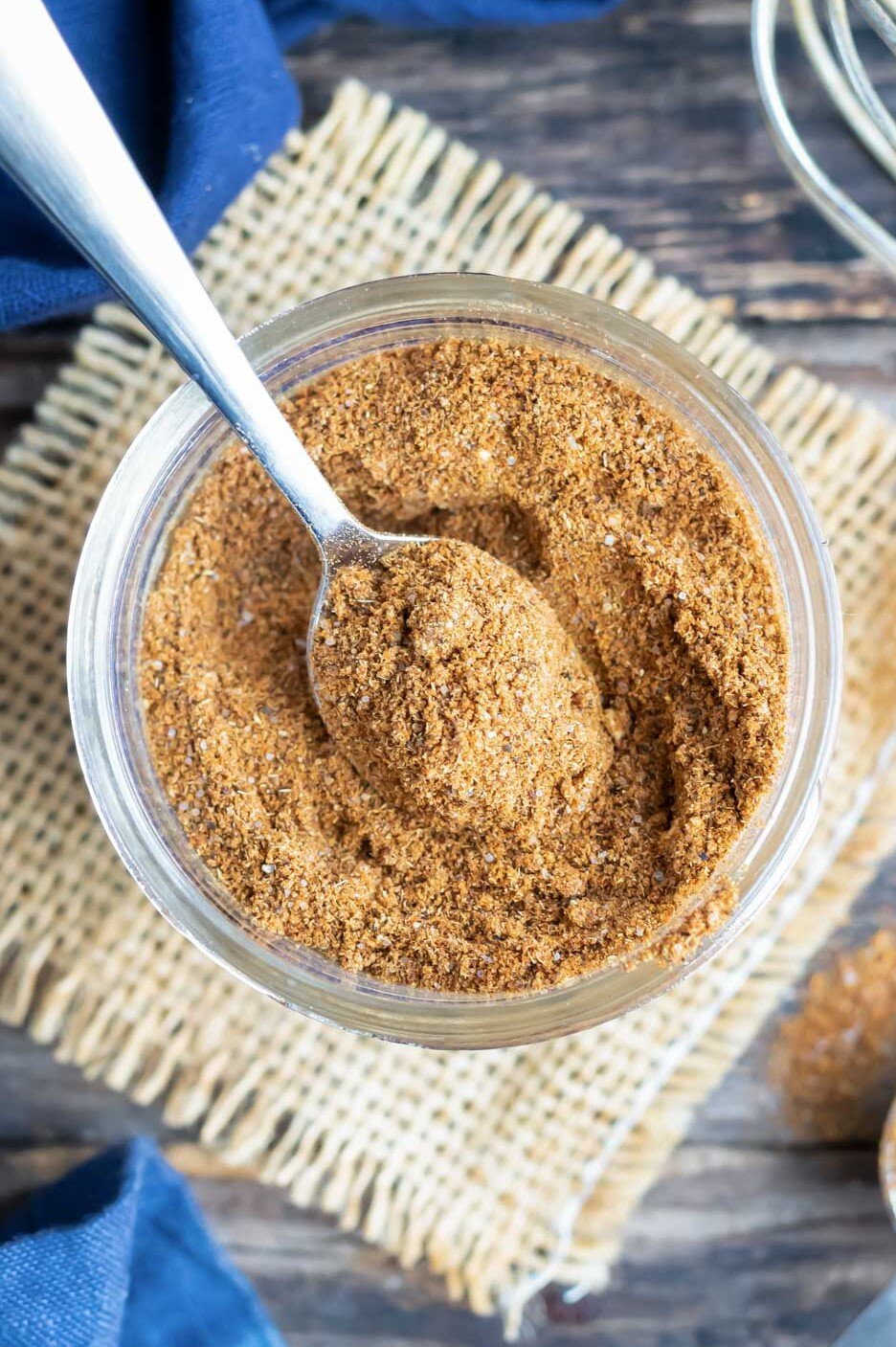 Gluten-Free Taco Seasoning Mix RECIPE served in a glass jar and a spoon.