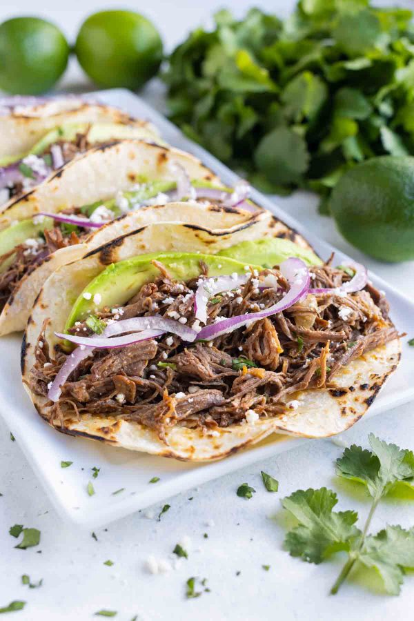 Tortillas are loaded with tender beef barbacoa and served.