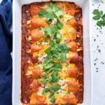 A large baking dish with an authentic and easy chicken Mexican casserole with cheese.