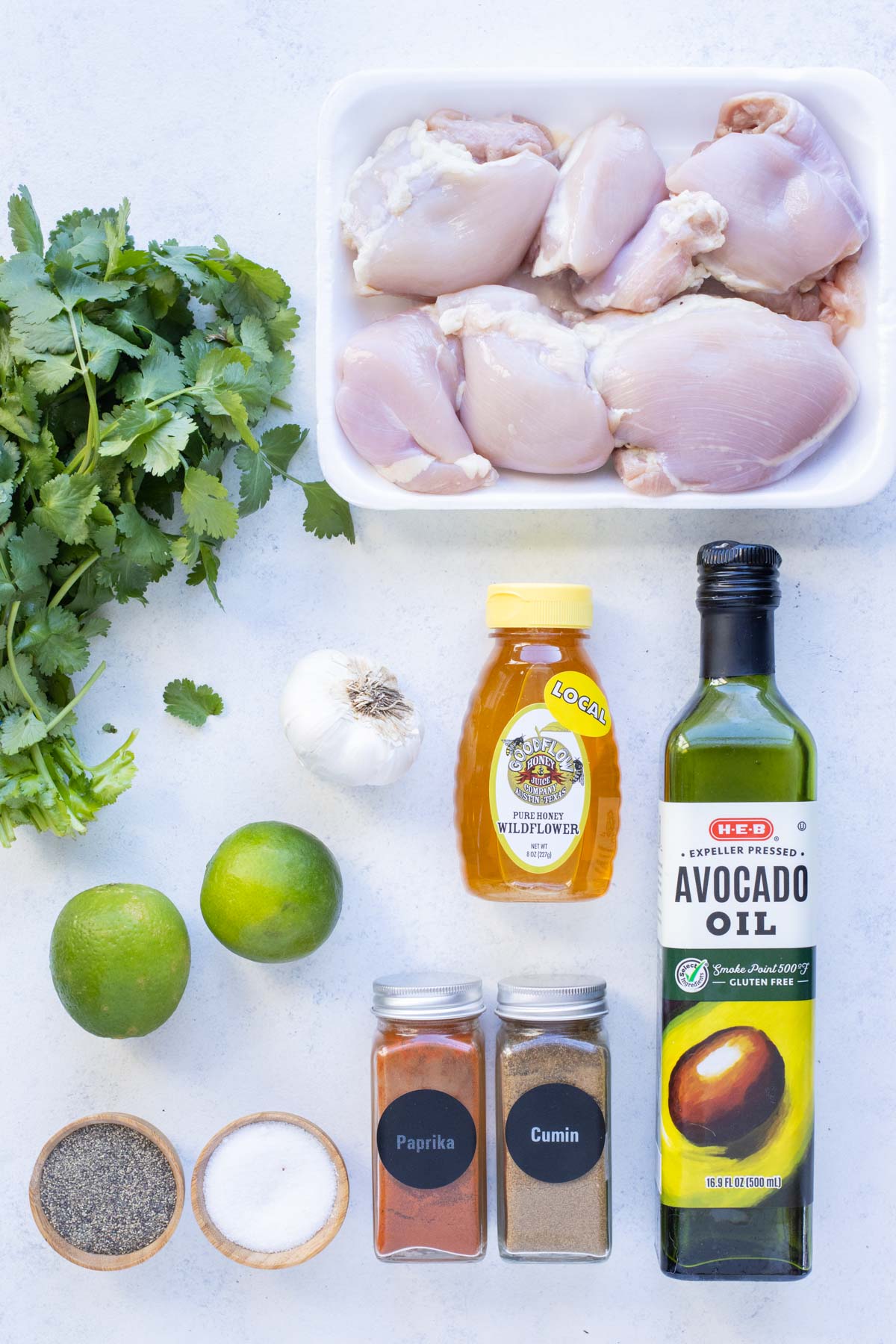 Chicken thighs, cilantro, lime, garlic, oil, honey, and seasonings are the ingredients for this recipe.