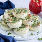 Healthy egg white bites are topped with fresh parsley before eating.