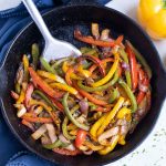 A cast-iron skillet is loaded with flavorful fajita veggies.