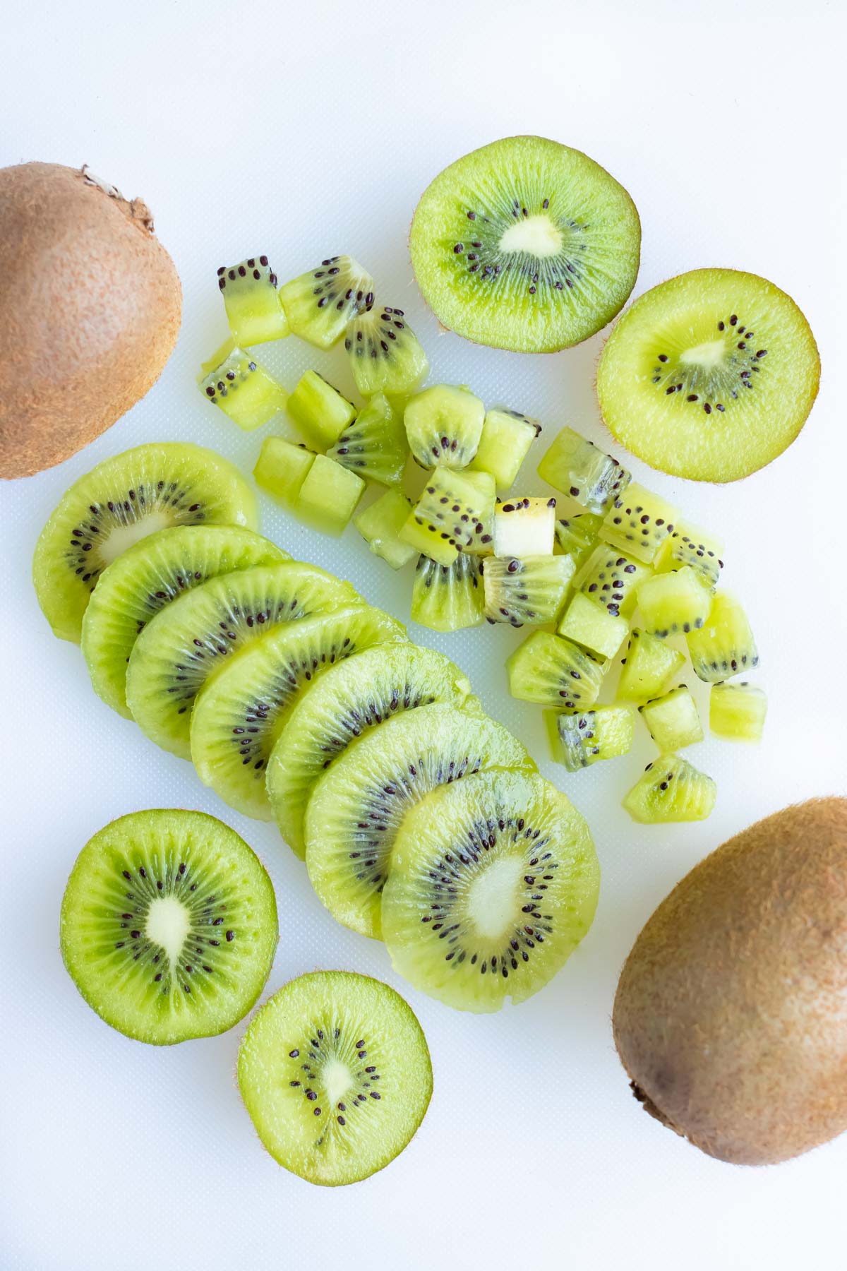 Kiwi is sliced, diced, and left in half pieces.