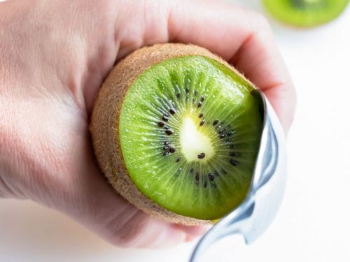 The kiwi half is removed and peeled with spoon method.