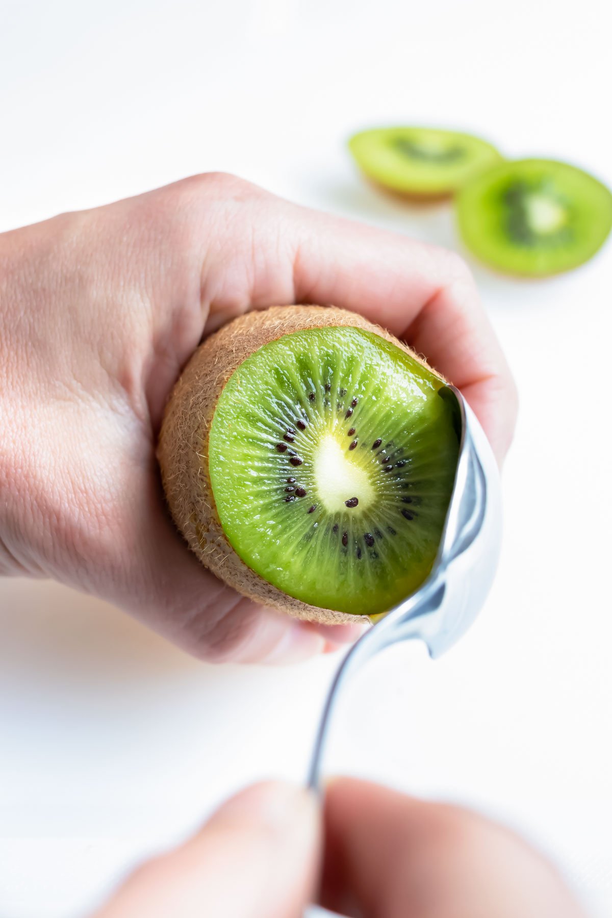 The kiwi half is removed and peeled with spoon method.