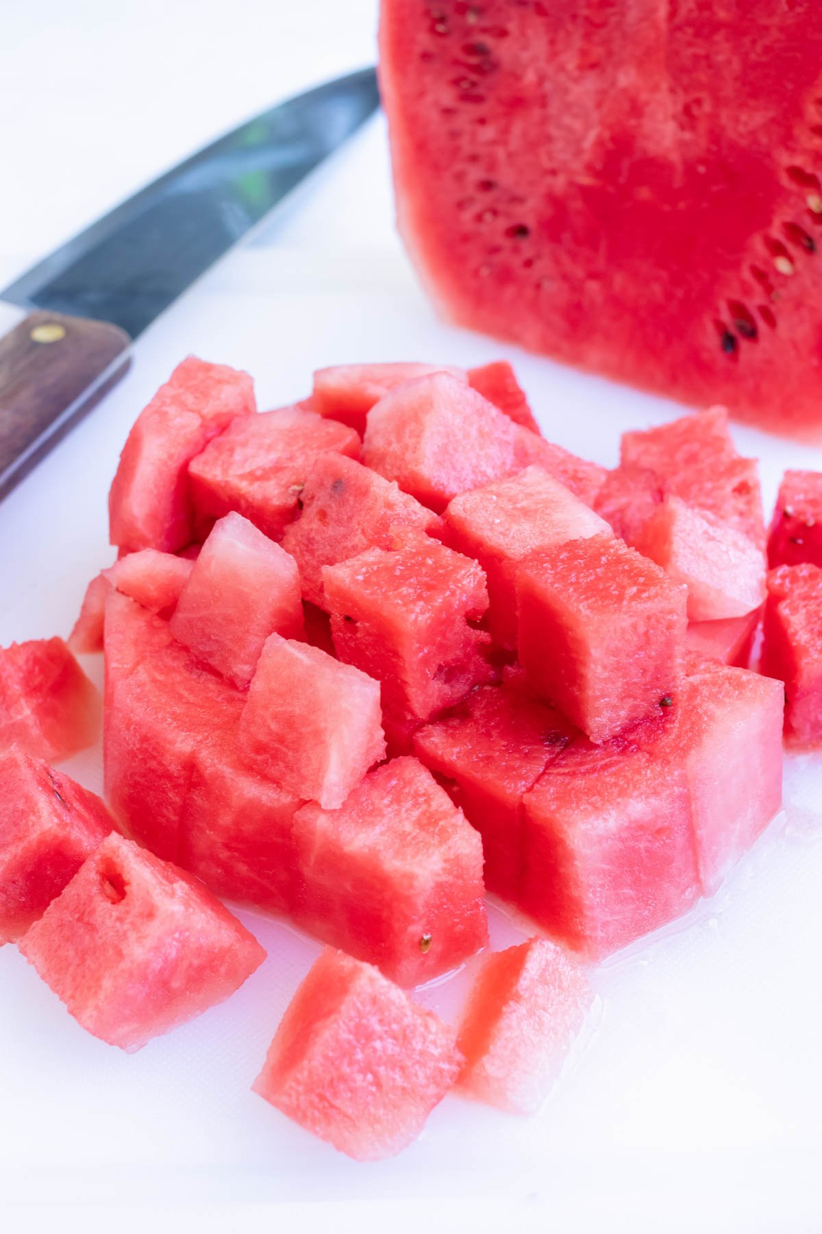 A cutting board with a rim around the edge to catch watermelon juice.