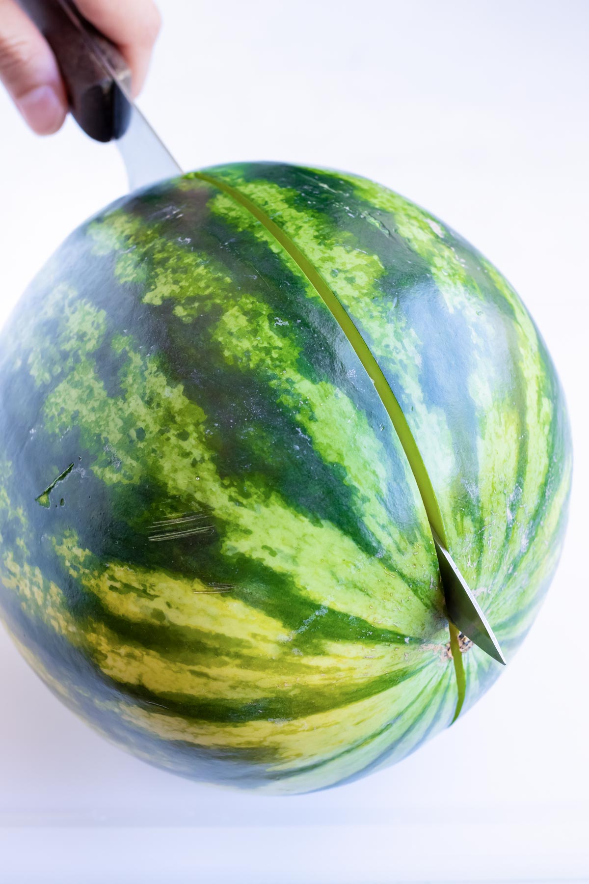 Slicing a watermelon in half