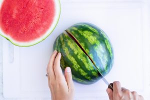 Slicing a watermelon into quarters