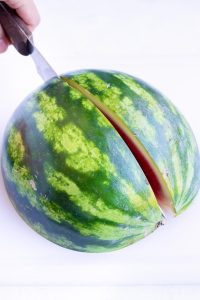 Slicing a watermelon into quarters