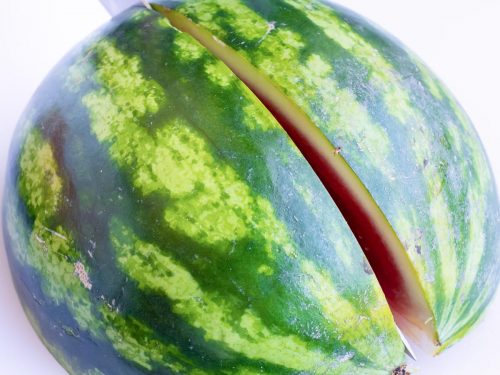 Slicing a watermelon into quarters