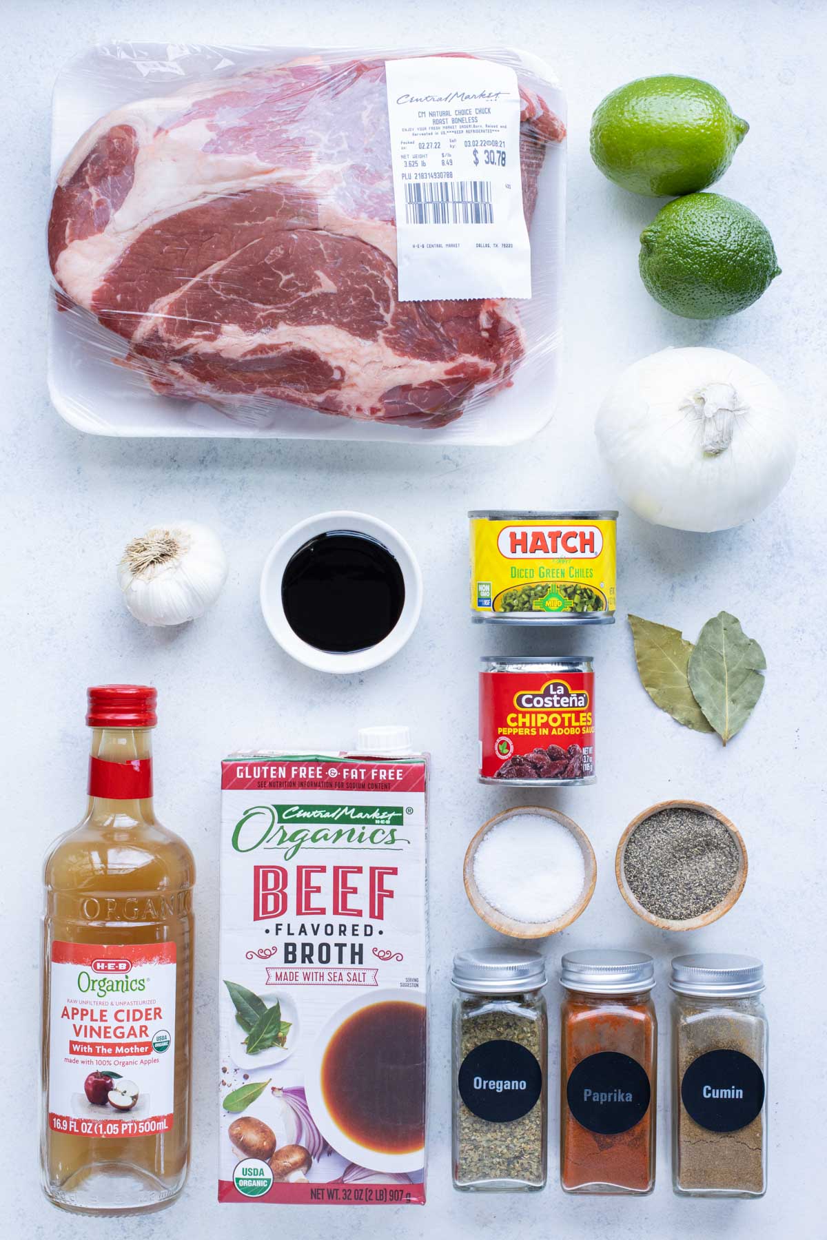 Chuck roast, chipotle chilis, broth, vinegar, molasses, limes, bay leaves, garlic, onion, green chilis, and seasonings are the ingredients for this recipe,