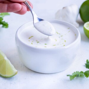 The Lime Crema is served from a white bowl on the counter.