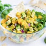 Quick, easy, and fresh mango avocado salsa recipe with a tortilla chip.