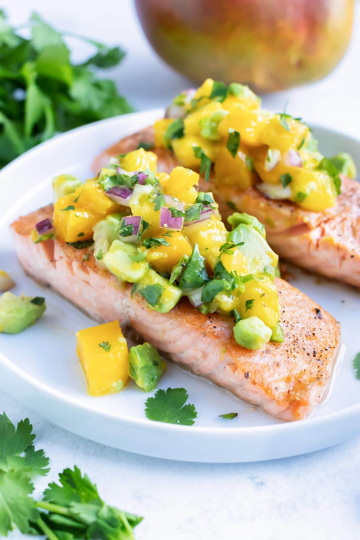 Salmon filets with mango avocado salsa on top.