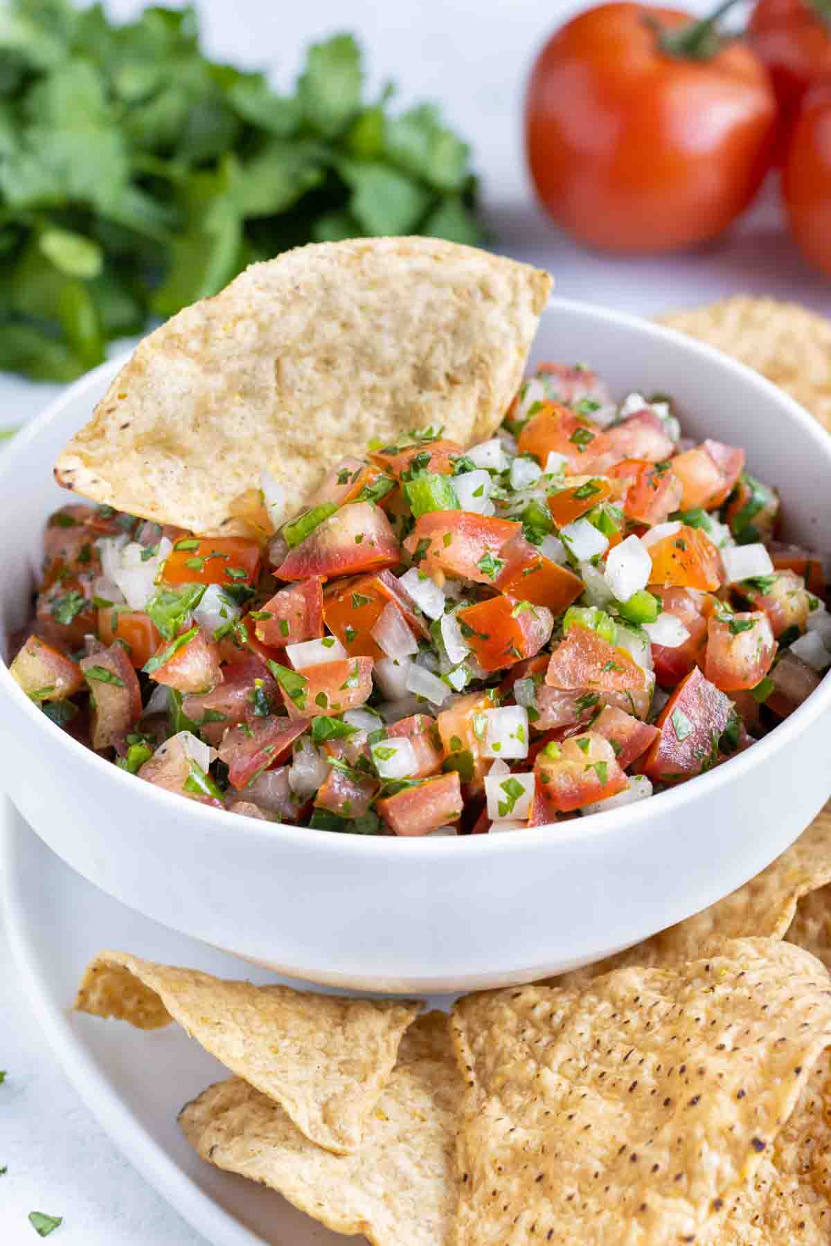 Chips are served along side a bowl of fresh and colorful pico.