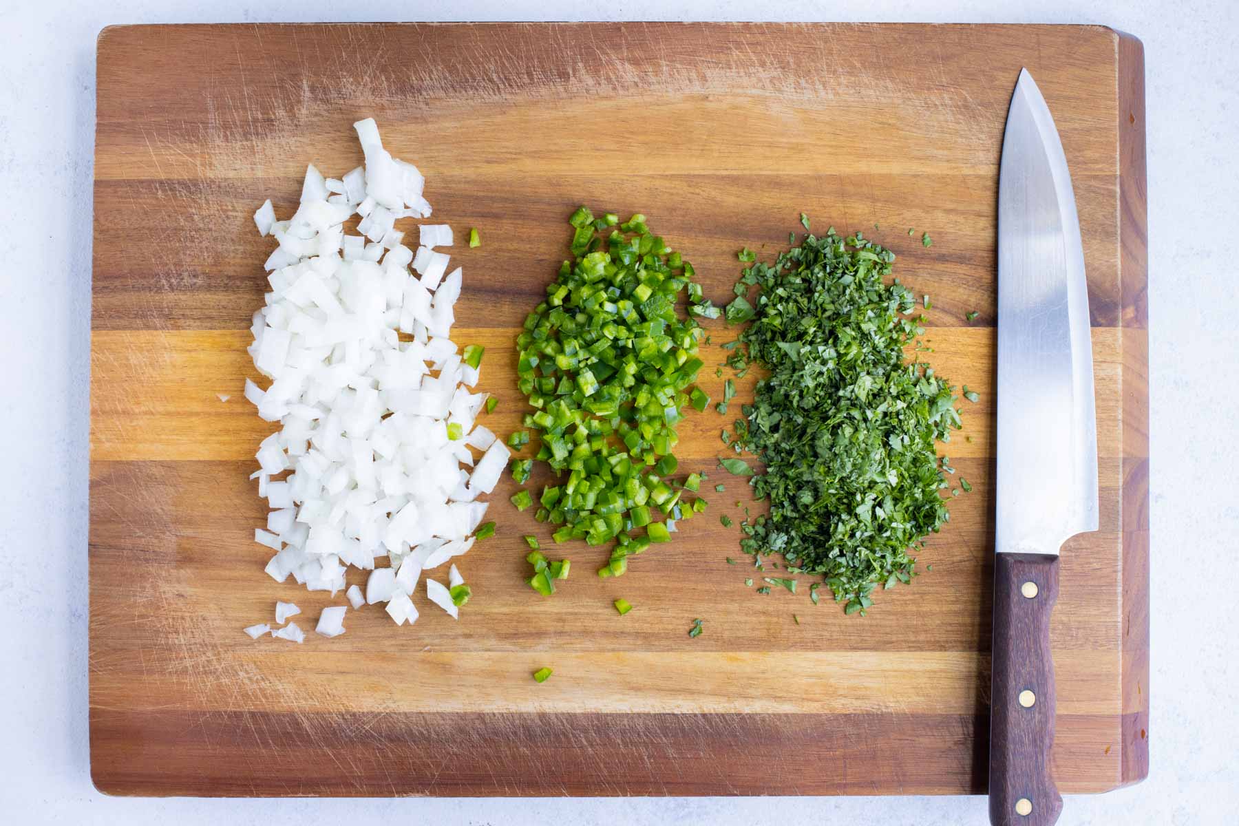Cilantro, onion, and jalapeno are diced into small pieces.