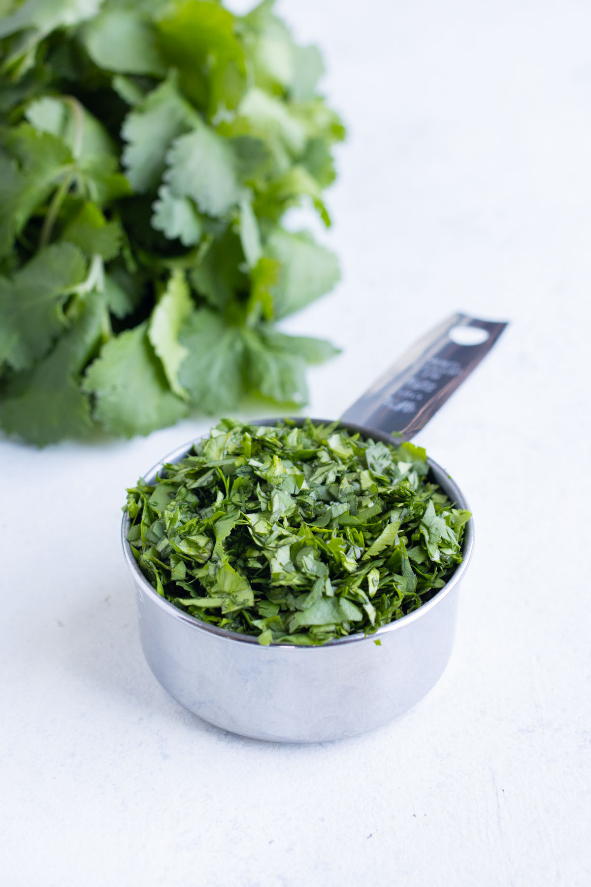 Cilantro is measured in a cup.