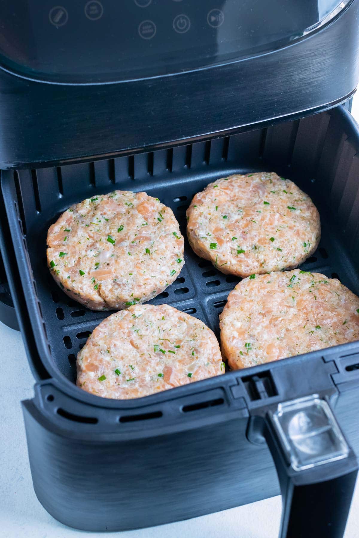 The four burgers are cooked in the air fryer.