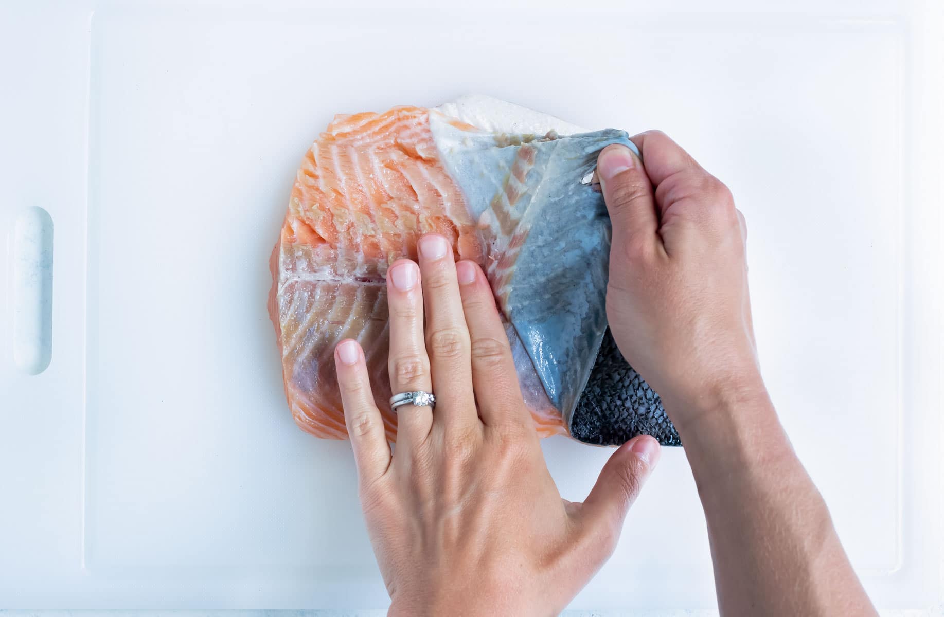 The skin is removed from the fresh salmon.