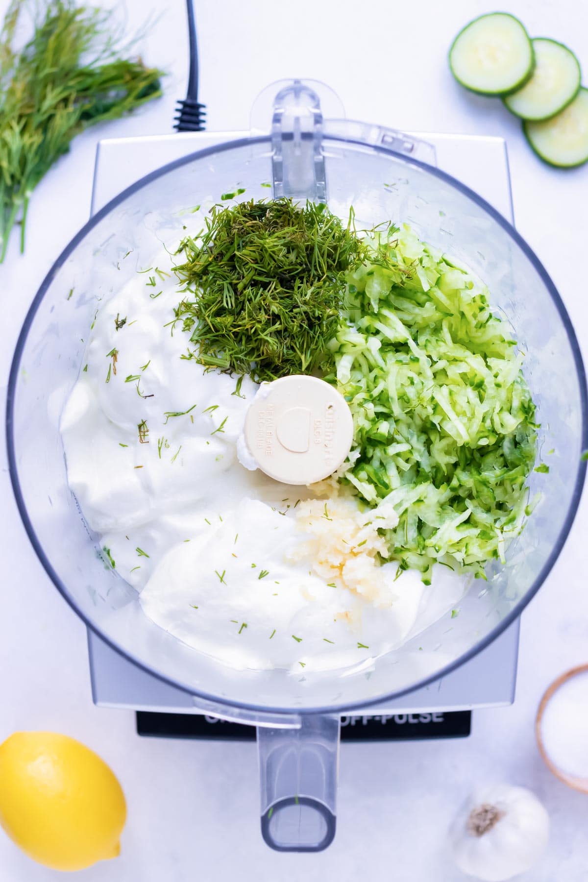 Learn how to make tzatziki sauce in a food processor by combining Greek yogurt, fresh dill, shredded cucumber, and other ingredients for an authentic Mediterranean dip.