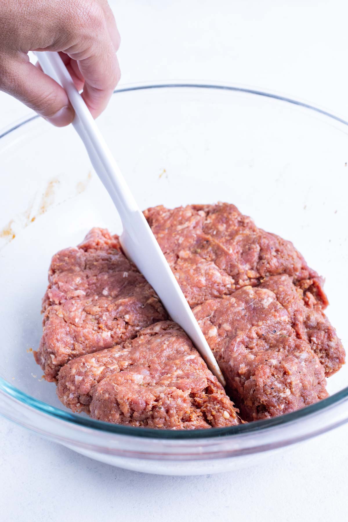 Hamburger meat is divided into four equal parts.