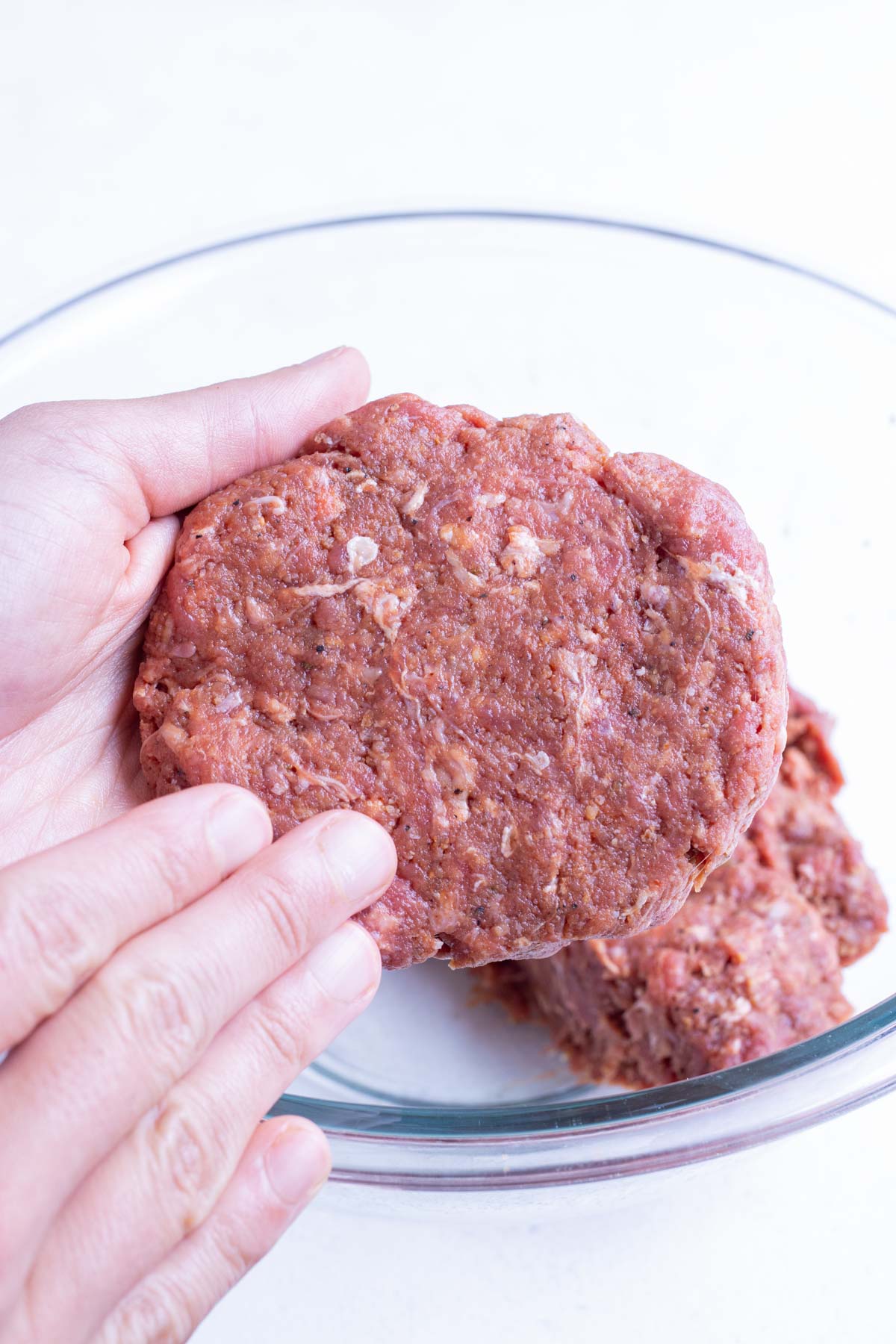 Meat is formed into patties using your hands.