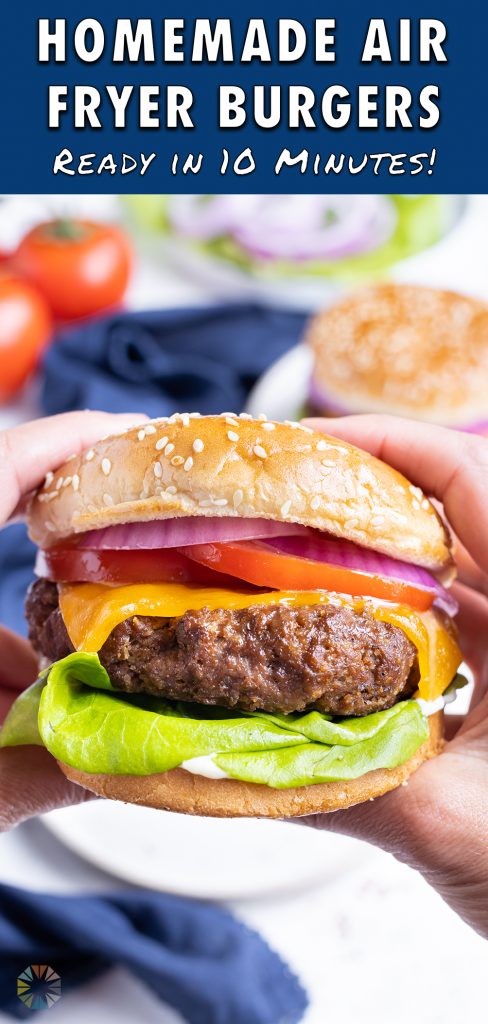 Hands are shown holding a hamburger before eating.