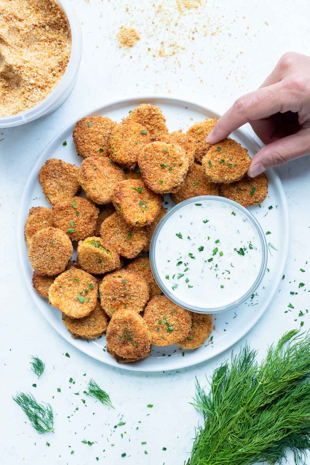 A plate of air fryer pickles is served for an appetizer.