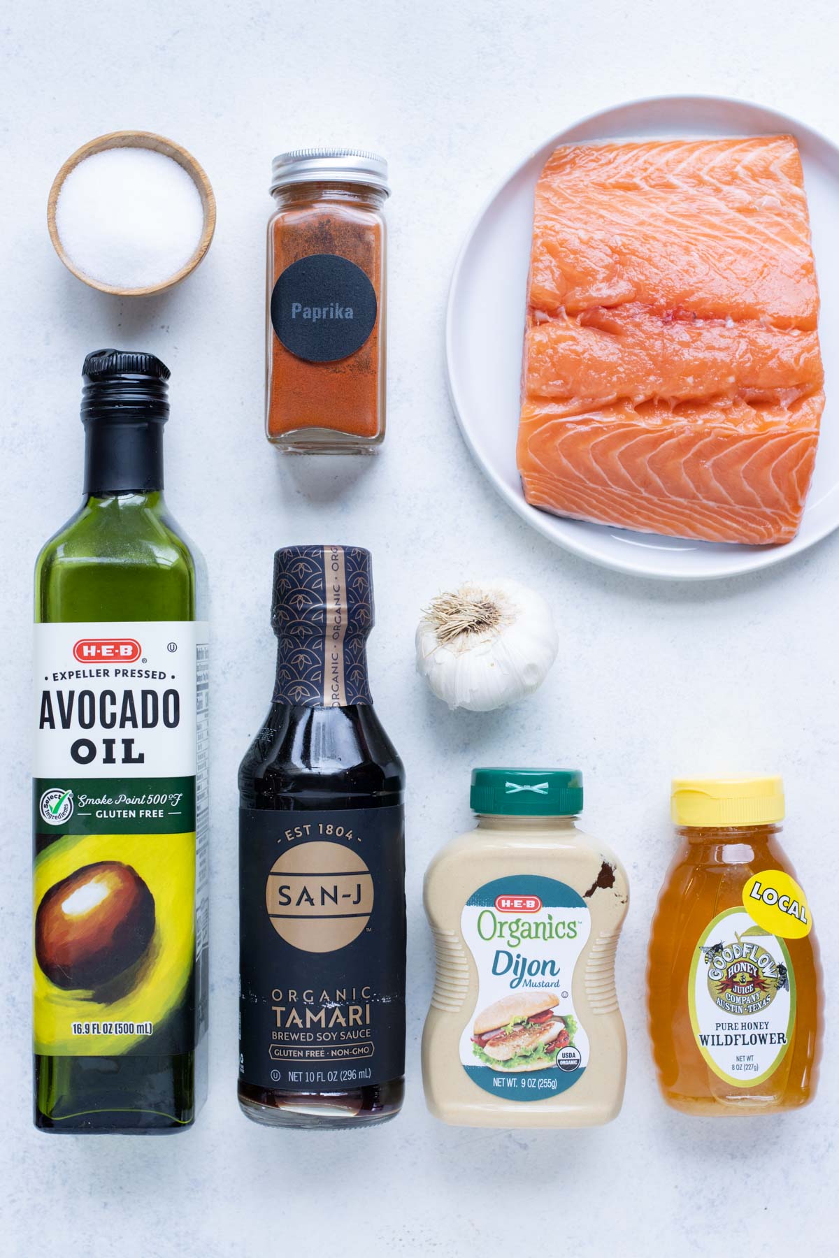 Salmon, honey, avocado oil, garlic, soy sauce, cayenne, and dijon mustard are the ingredients for this recipe.