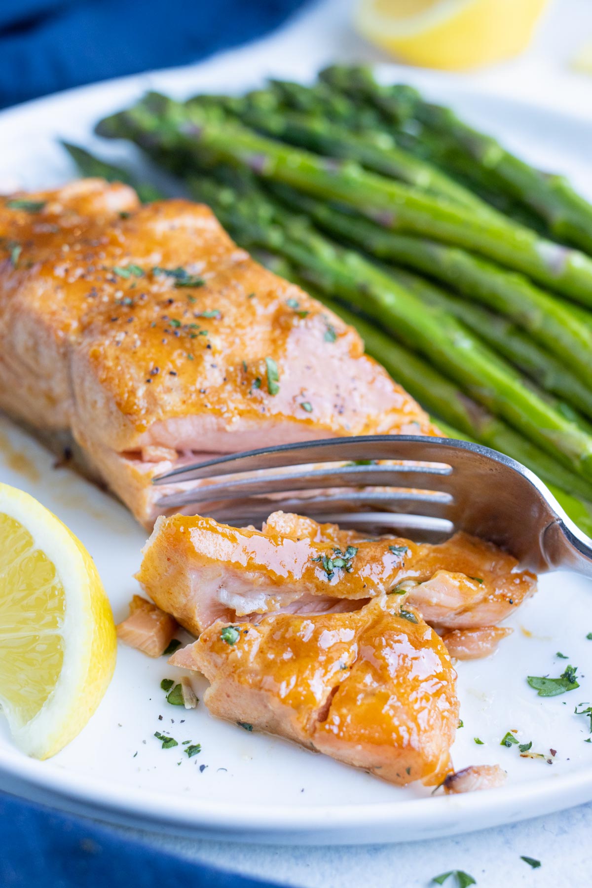 A fork is shown cutting into tender air fryer salmon.