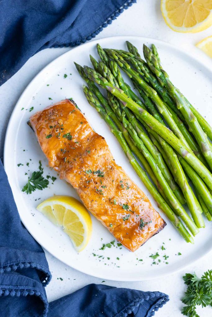 Asparagus is paired with tender and flaky Air Fryer Salmon.