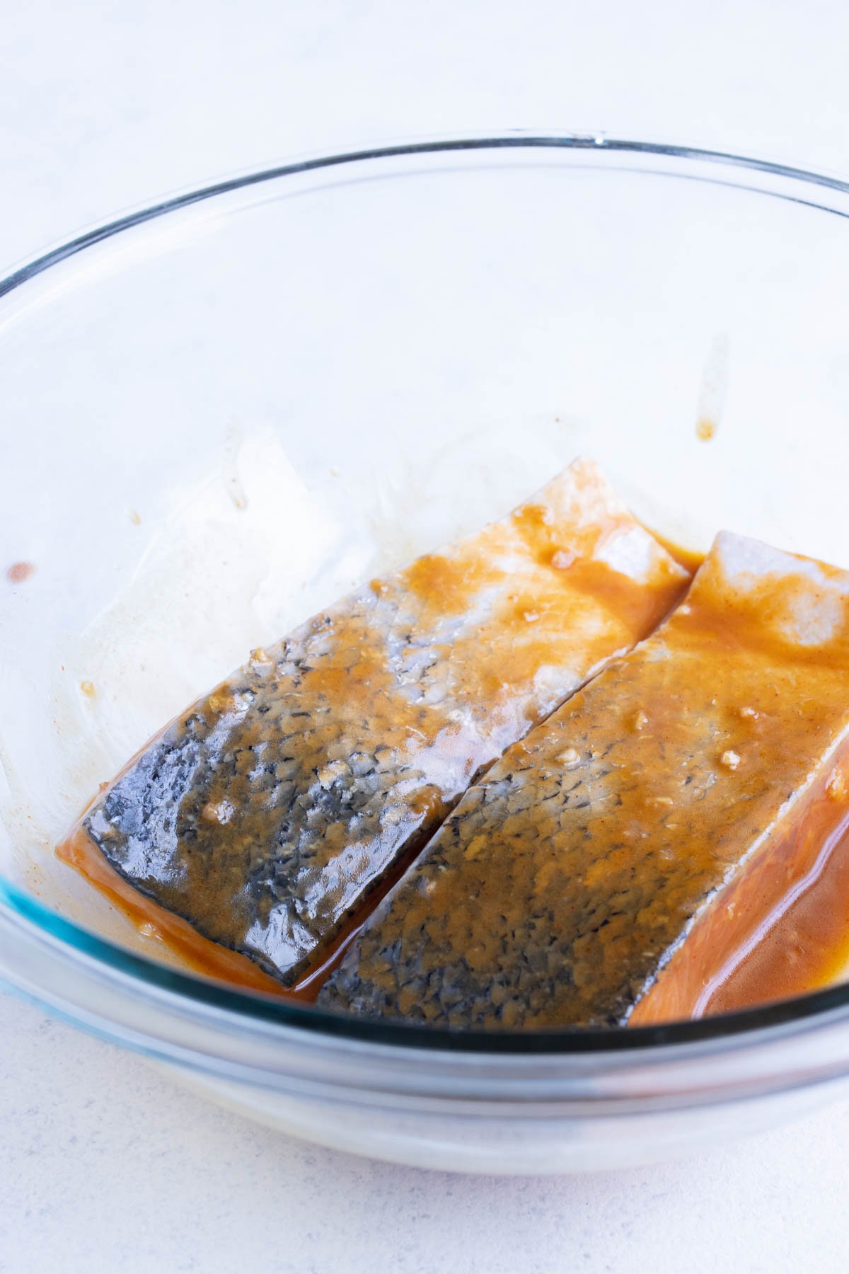 Salmon is put in the marinade before cooking.