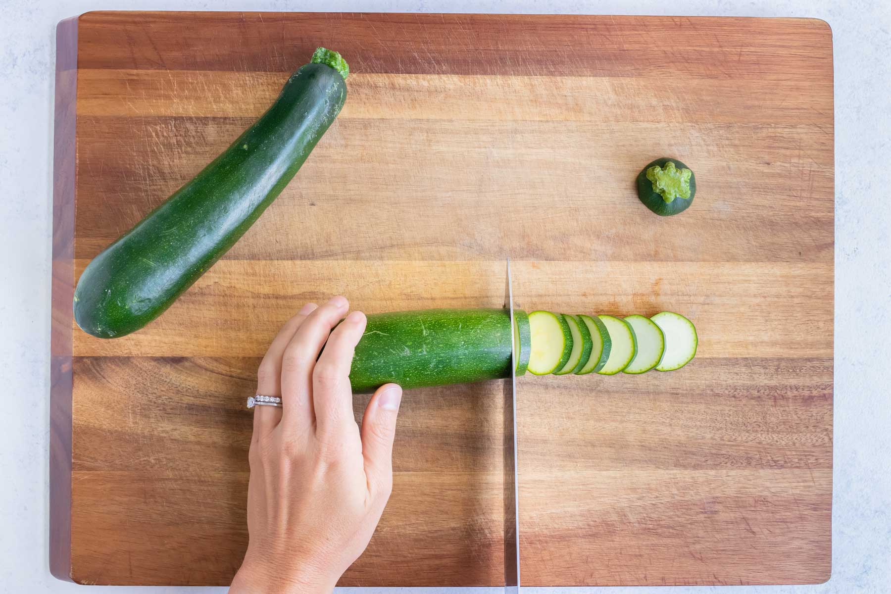 Zucchini is cut into slices on a cutting board. for this healthy recipe.