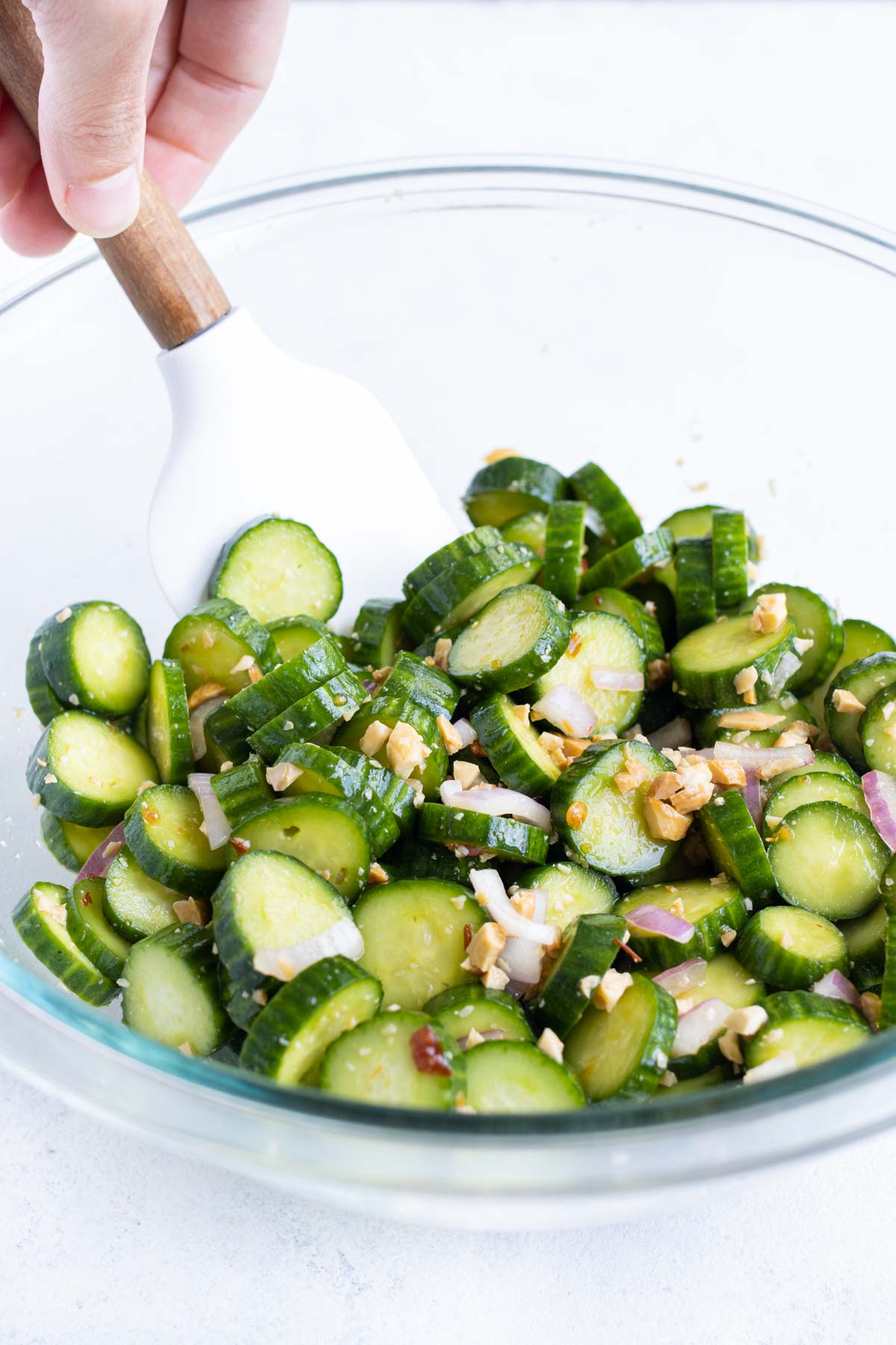 Sliced cucumbers with dressing poured on top.