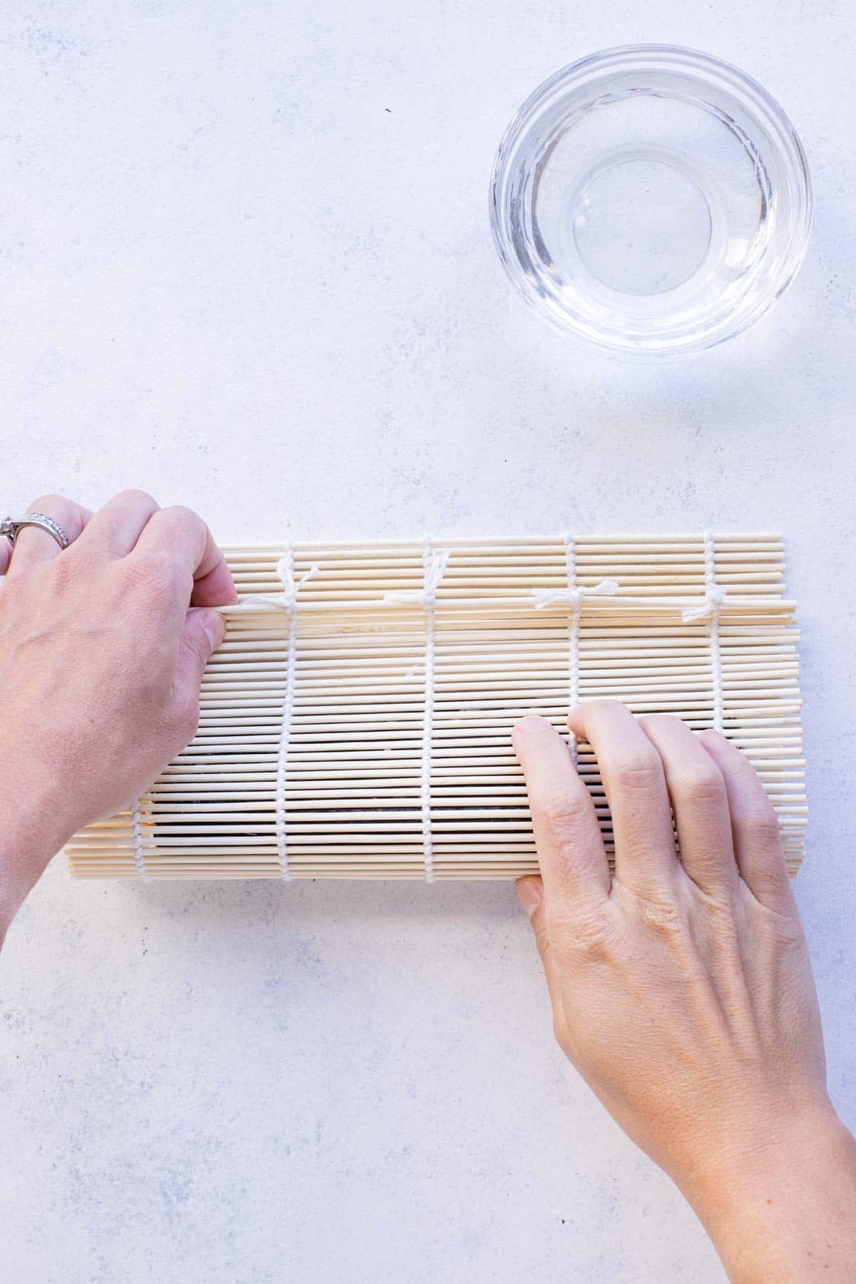 A bamboo mat is used to roll the sushi.