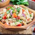 A wooden salad bowl full of a cold BLT pasta salad recipe.