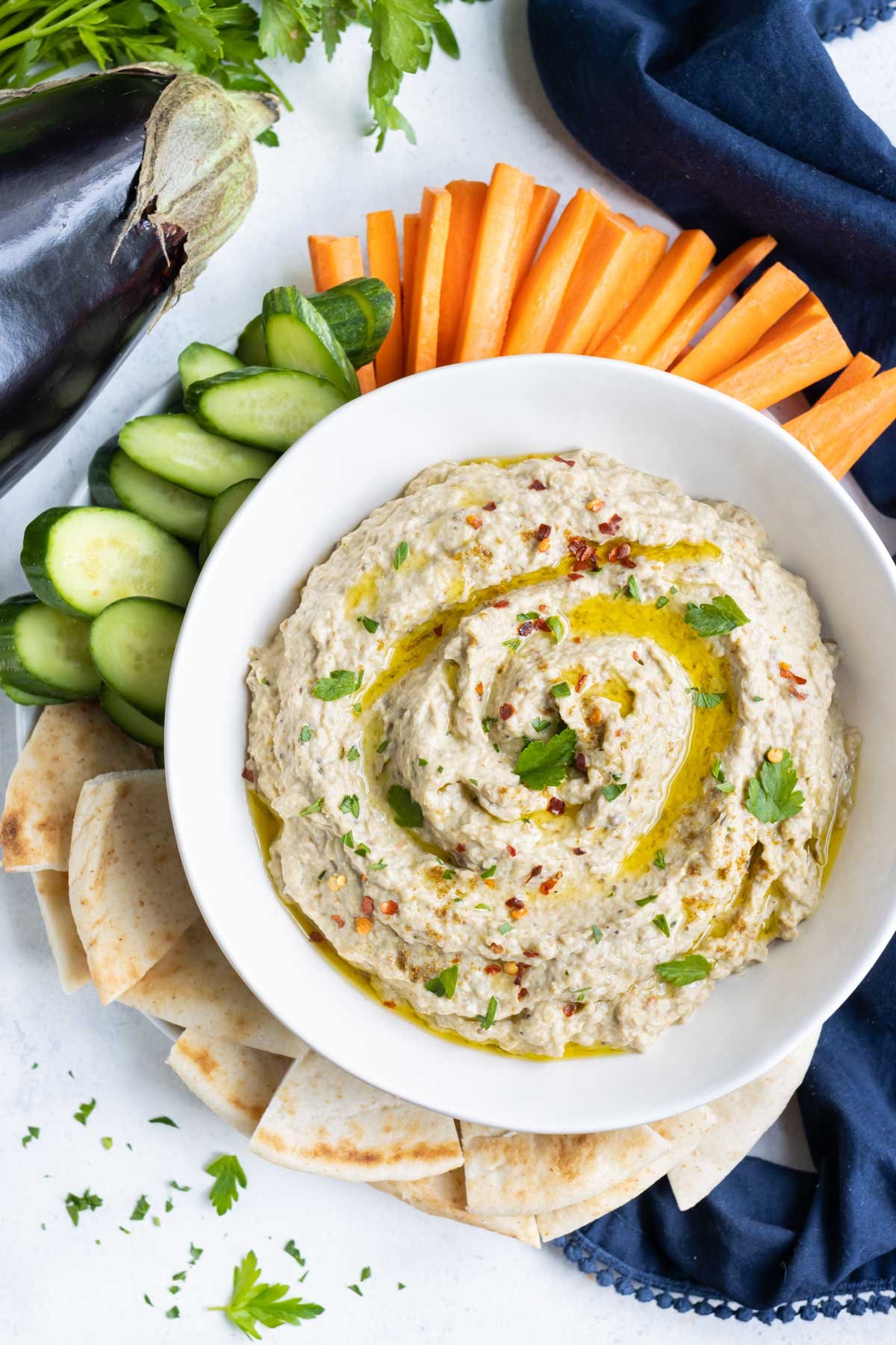 A platter with veggies and pita to drip in vegan baba ganoush.