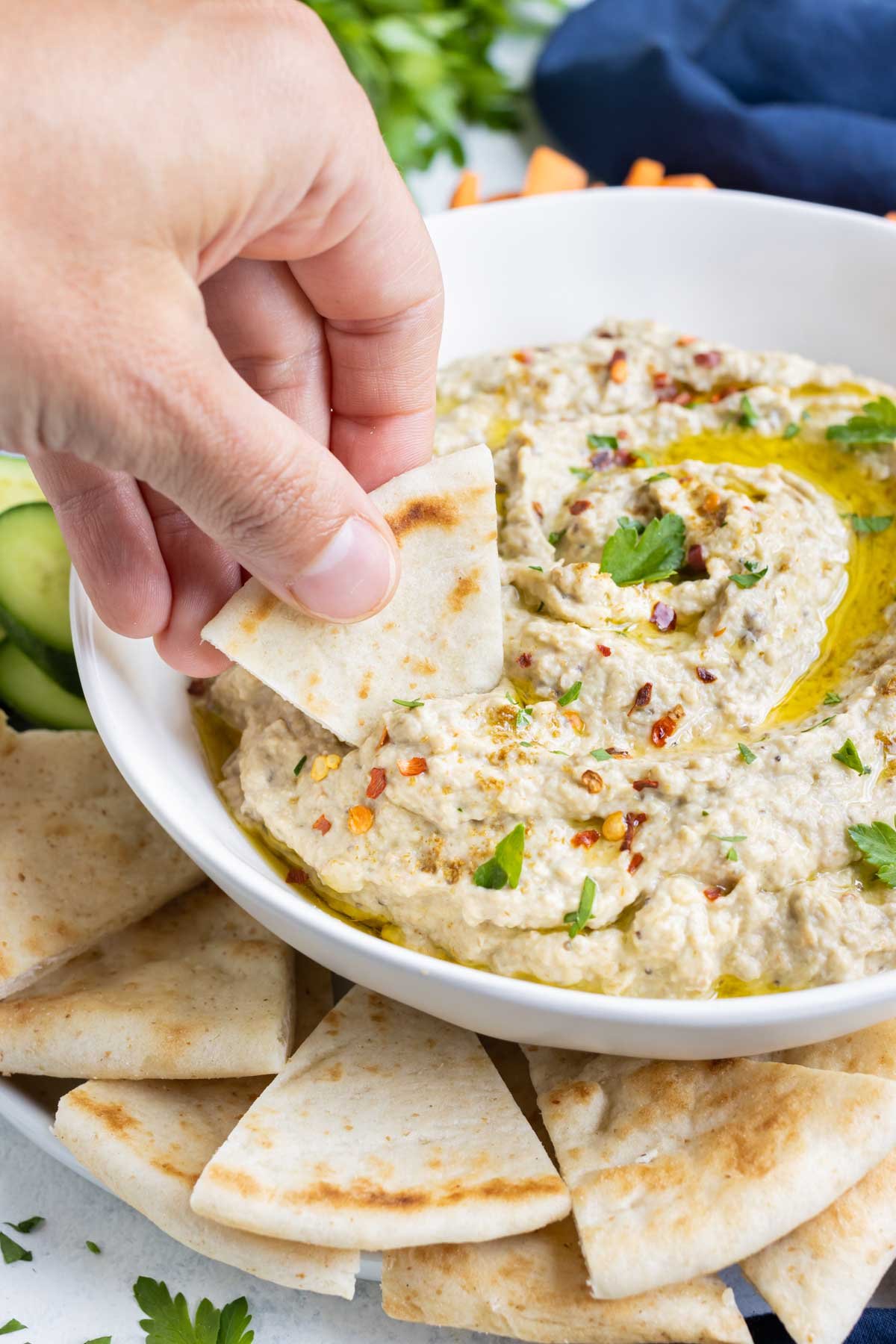 Homemade pita bread is dipped into an eggplant spread.