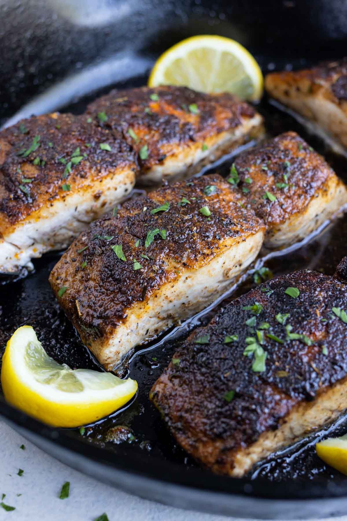 Mahi mahi is shown in a cast iron skillet after cooking.