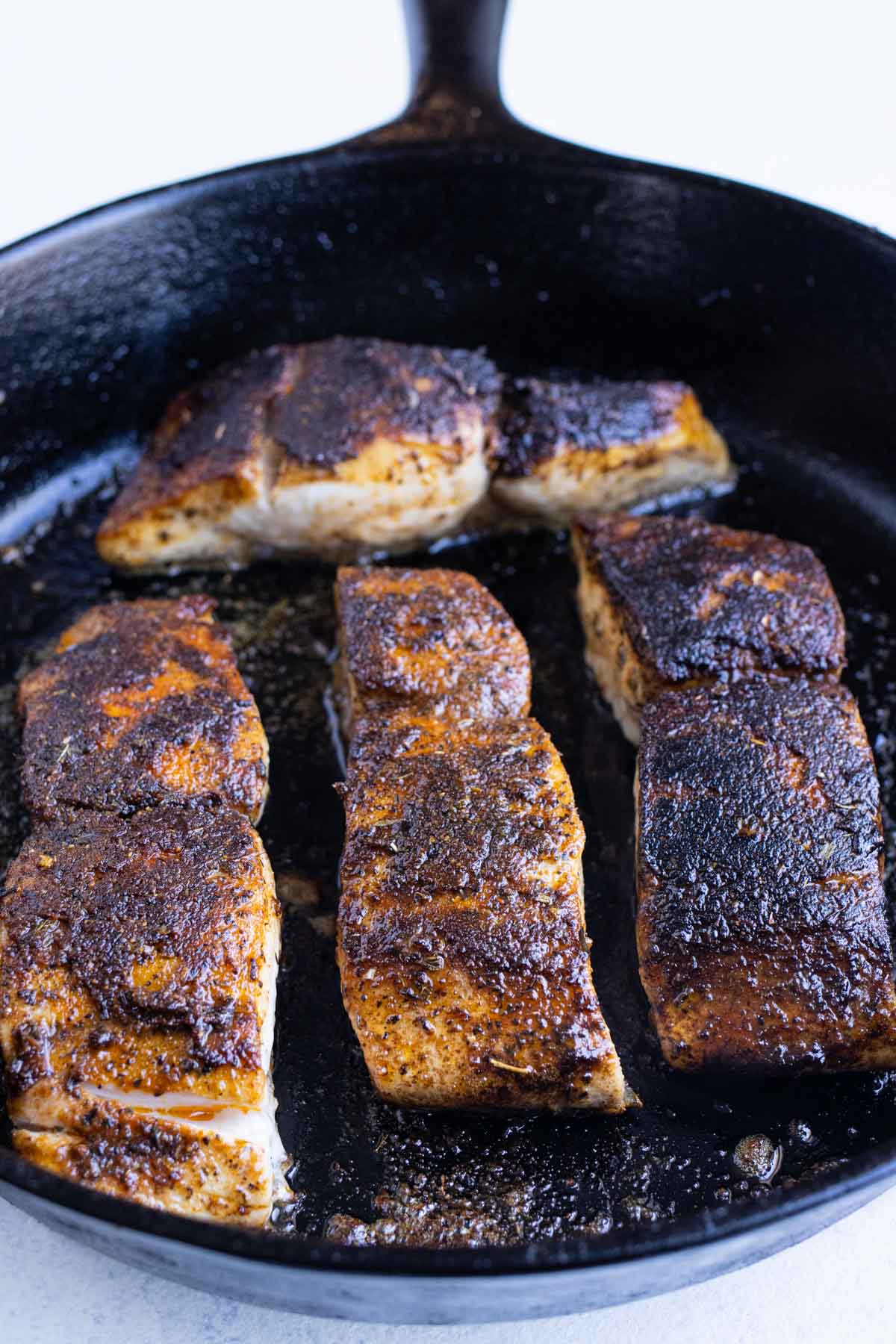 Mahi mahi is flipped and continued to be cooked.