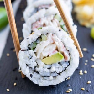 Chopsticks are used to eat sushi rolls.