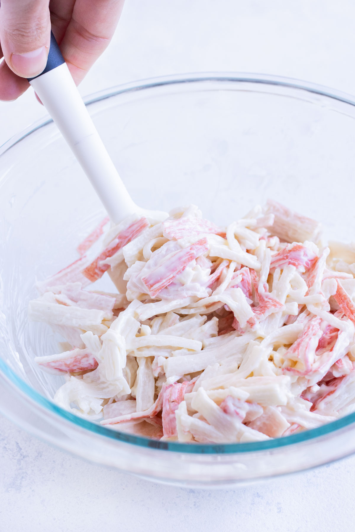 Imitation crab is combined with mayo before filling sushi.