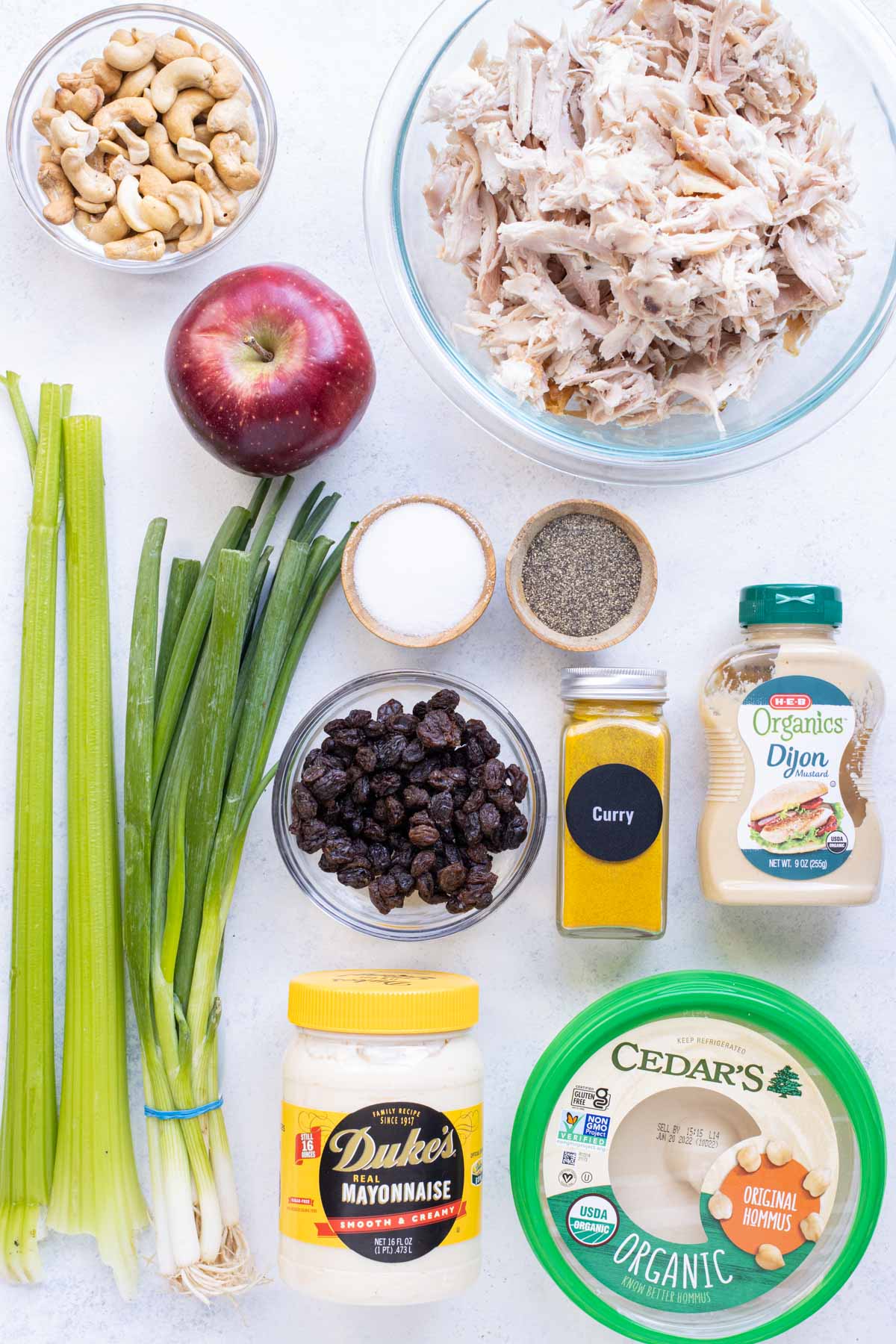 Shredded chicken, hummus, apples, green onions, celery, cashews, salt. pepper. craisins, curry powder, dijon mustard, and, mayonnaise are the ingredients for this recipe.