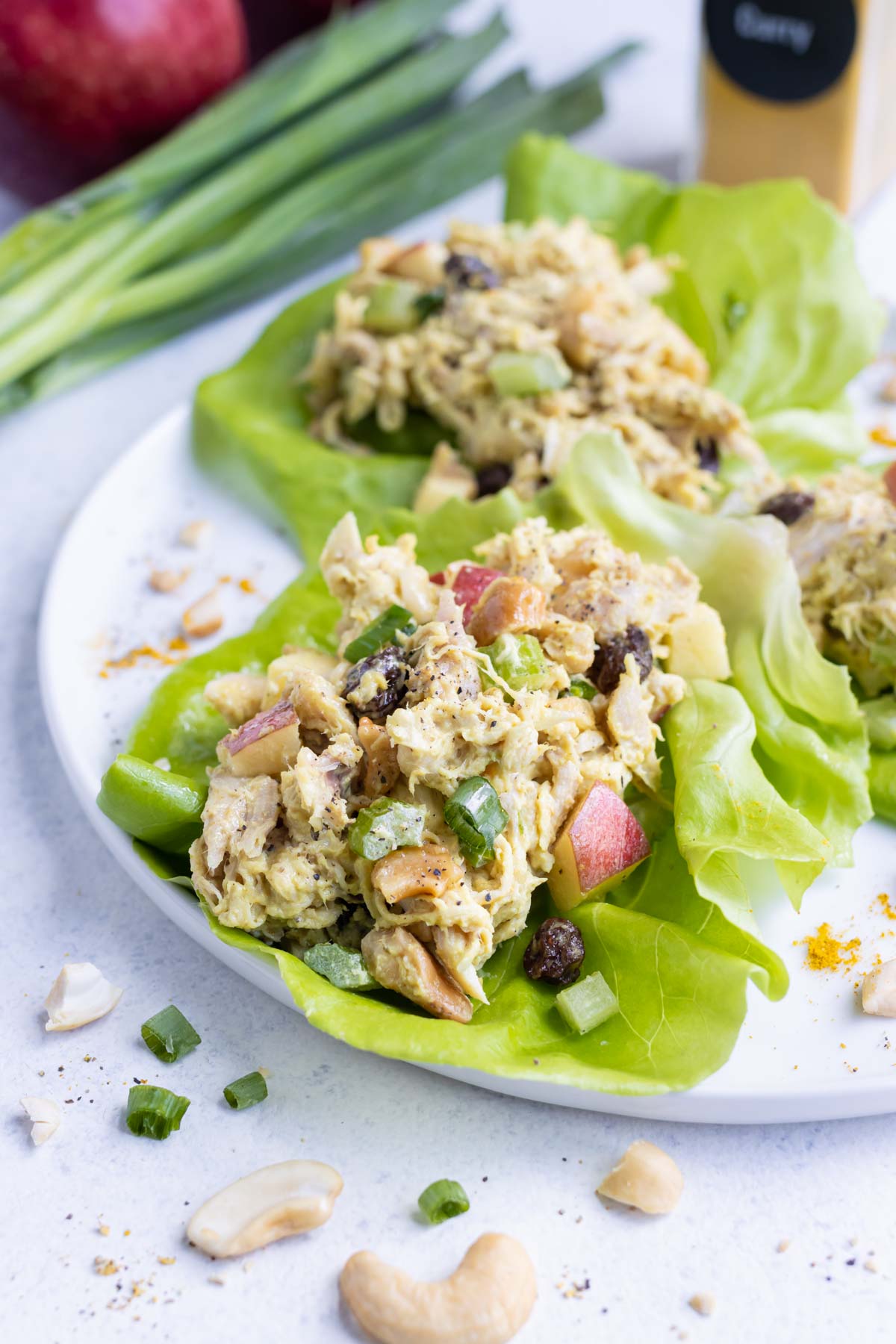 Curry chicken salad is wrapped in butter lettuce leaves.