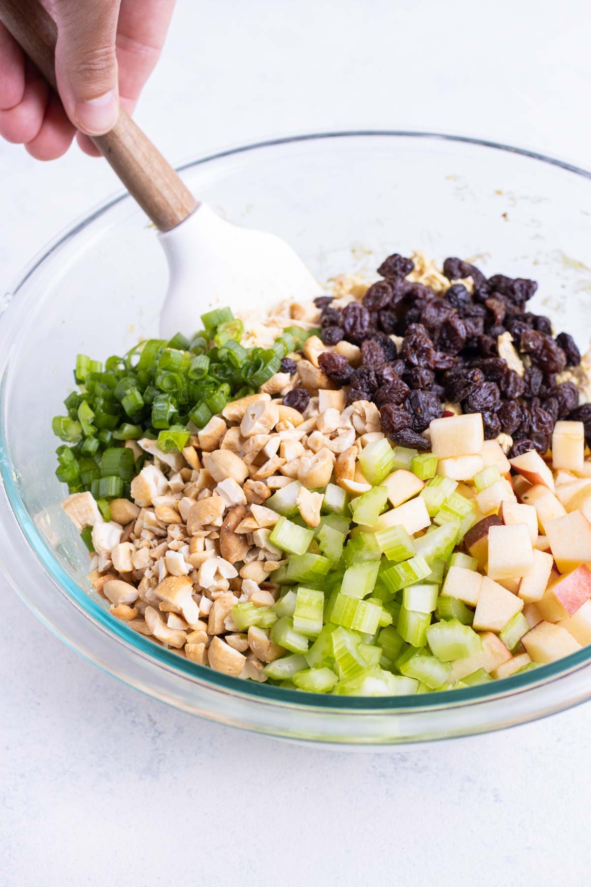 Chopped ingredients are added to the chicken.