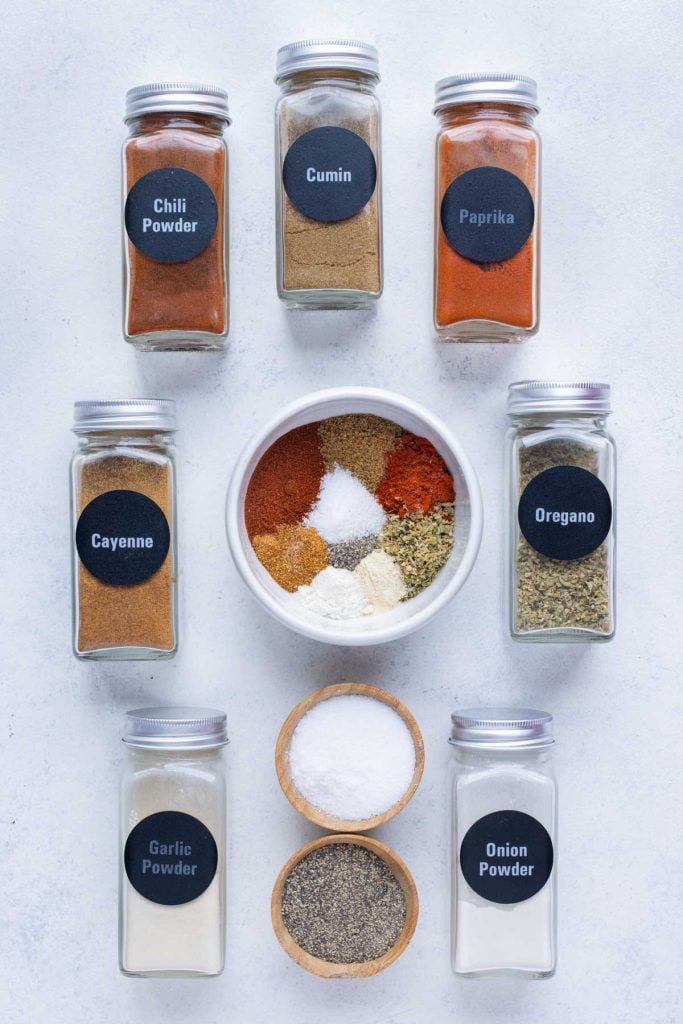 Homemade fajita seasoning spices in small bowls on a cutting board