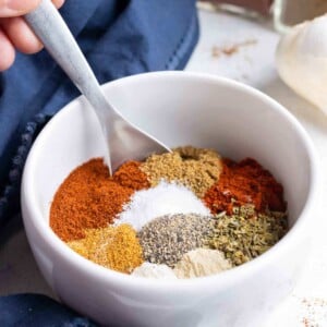 Paprika, chili powder, cayenne powder are some of the ingredients combined in the bowl.