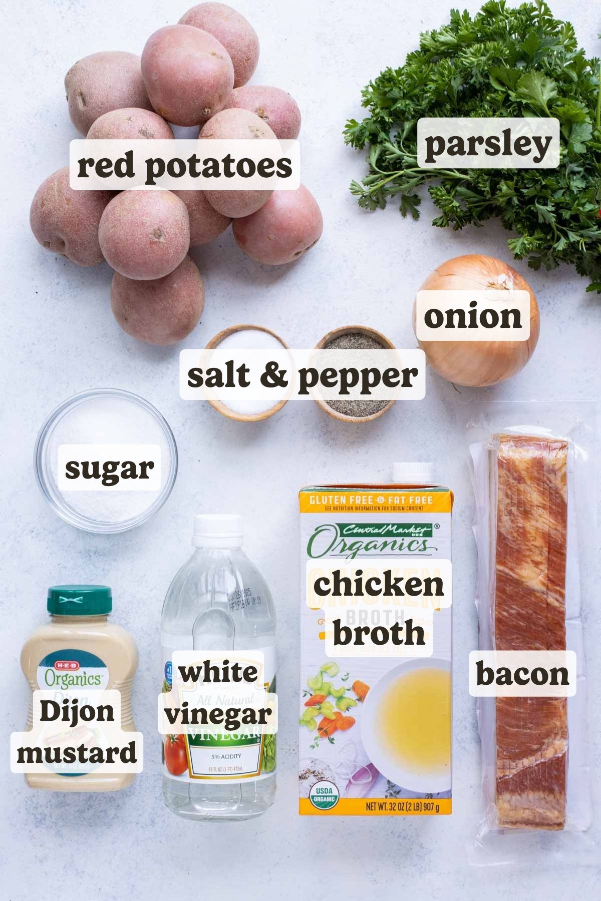 Red potatoes, onion, bacon, white vinegar, salt, pepper, chicken broth, sugar, and parsley are the ingredients for this German potato salad recipe.
