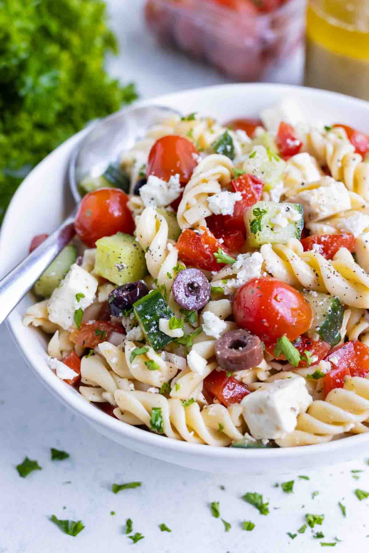 Pasta salad is shown in a white bowl for a gluten-free side.
