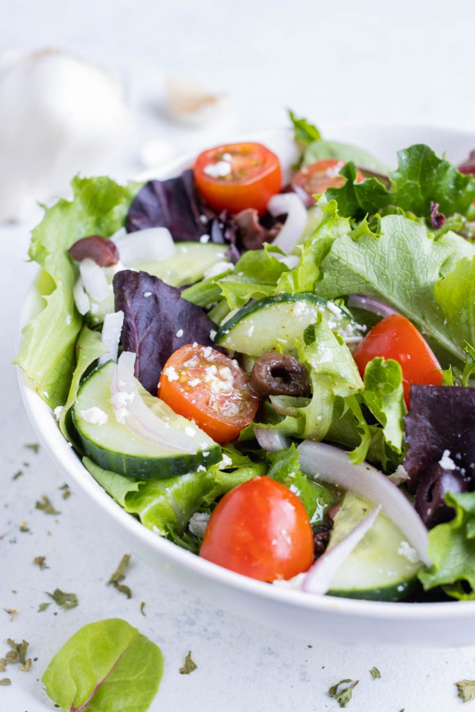Salad is tossed in a homemade Greek salad dressing.